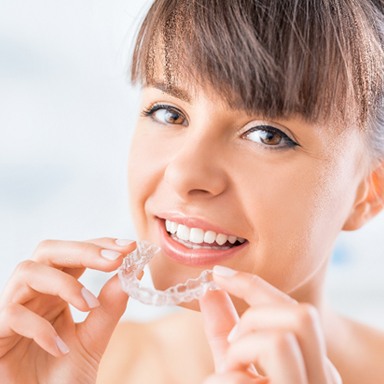 Woman about to put in aligner